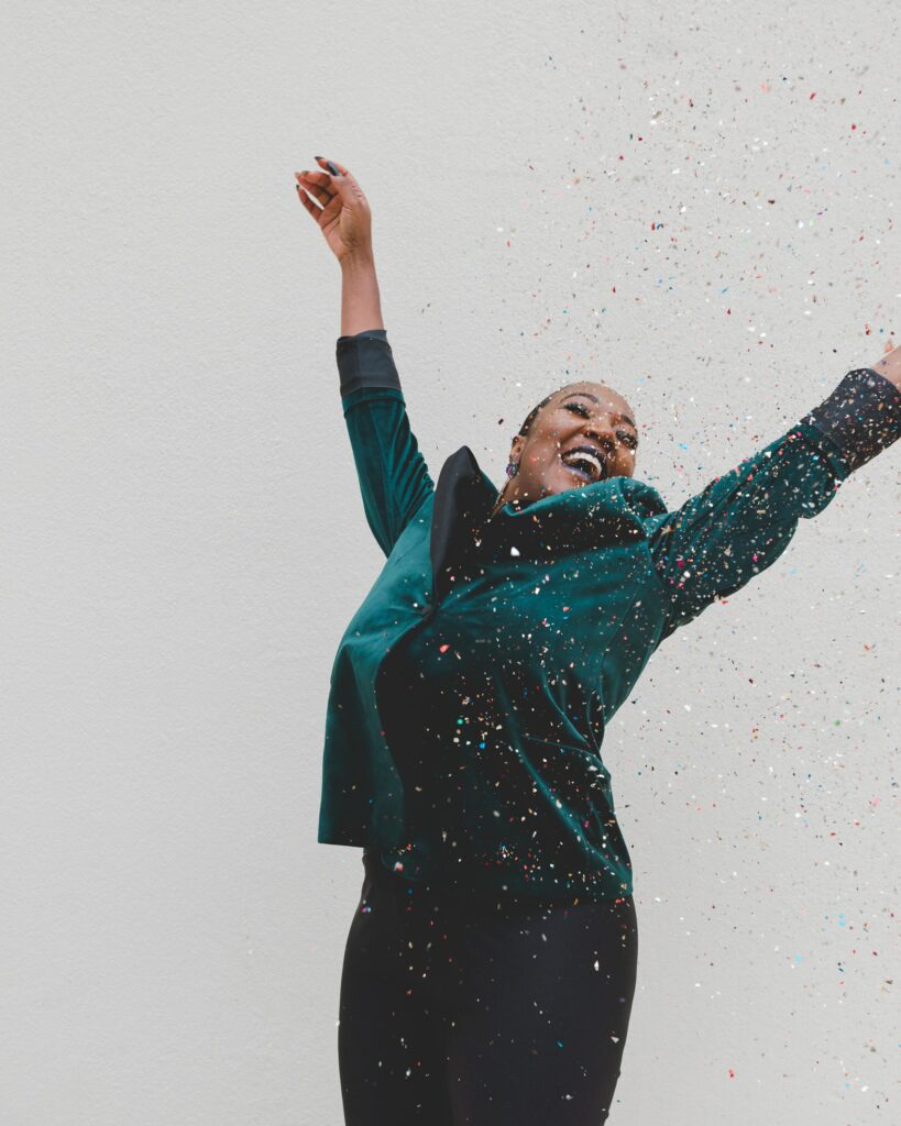 happy woman jumping in confetti